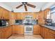 Traditional kitchen featuring wood cabinets, stainless steel appliances, and dark granite countertops at 5950 Cypress Grove Cir, Punta Gorda, FL 33982