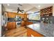 Galley kitchen featuring dark granite counters, wood cabinets, and stainless steel appliances at 5950 Cypress Grove Cir, Punta Gorda, FL 33982