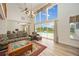 Bright living room featuring a wall of windows overlooking the pool and a large sofa at 5950 Cypress Grove Cir, Punta Gorda, FL 33982
