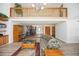 Open-concept living room showcasing a balcony, staircase, and seamless wood-look flooring at 5950 Cypress Grove Cir, Punta Gorda, FL 33982