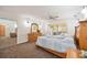 Bright primary bedroom with a dresser, slider doors, and carpet flooring at 5950 Cypress Grove Cir, Punta Gorda, FL 33982