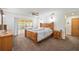 Main bedroom with neutral tones and a sliding glass door providing access to the outdoors at 5950 Cypress Grove Cir, Punta Gorda, FL 33982