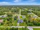 Aerial view of home surrounded by lush trees, showcasing its property lines at 6444 Alhambra Ave, North Port, FL 34291