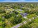 Aerial view of home surrounded by lush trees, highlighting its serene location at 6444 Alhambra Ave, North Port, FL 34291