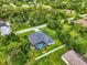 An aerial view showcases the property's layout, pool, landscaping, and surrounding neighborhood at 6444 Alhambra Ave, North Port, FL 34291