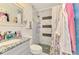 Modern bathroom with a marble-tiled shower, vanity, and gray pebble flooring at 6444 Alhambra Ave, North Port, FL 34291