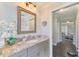 Elegant bathroom with granite countertops, designer mirror, and access to additional rooms at 6444 Alhambra Ave, North Port, FL 34291