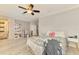 Light-filled bedroom with a work area, ceiling fan, and an ensuite bathroom at 6444 Alhambra Ave, North Port, FL 34291