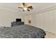 This bedroom has a ceiling fan, a large dresser with a TV, and a double door closet at 6444 Alhambra Ave, North Port, FL 34291