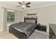 Cozy bedroom with a ceiling fan, a window with blinds, and neutral colored walls at 6444 Alhambra Ave, North Port, FL 34291