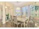 Bright dining room with chandelier, silver table and chairs, and decorative display cabinet at 6444 Alhambra Ave, North Port, FL 34291