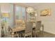 Elegant dining room featuring a decorative chandelier, silver table set, and wainscoting at 6444 Alhambra Ave, North Port, FL 34291