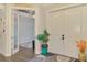 Welcoming foyer featuring a double-door entry and view to home office through glass doors at 6444 Alhambra Ave, North Port, FL 34291