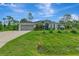A beautifully landscaped home with a well-manicured lawn and a two-car garage at 6444 Alhambra Ave, North Port, FL 34291