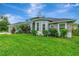 Beautiful home with a blend of stucco and stone and a pristine green lawn at 6444 Alhambra Ave, North Port, FL 34291
