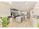 Open kitchen and living area showcasing a large island, modern appliances, and ample natural light at 6444 Alhambra Ave, North Port, FL 34291