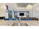 Open-concept living room with a large kitchen island, modern lighting, and a comfortable seating area with blue accents at 6444 Alhambra Ave, North Port, FL 34291