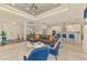 Open-concept living room with a large sectional sofa, modern lighting, and seamless flow to the kitchen area at 6444 Alhambra Ave, North Port, FL 34291