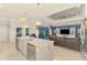 Spacious living area with a kitchen island, stainless steel appliances, and a bright, airy atmosphere at 6444 Alhambra Ave, North Port, FL 34291