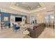 Bright living room featuring a modern ceiling fan, comfortable seating, and a stylish entertainment center at 6444 Alhambra Ave, North Port, FL 34291