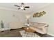 Elegant living room with modern ceiling fan, wood floors, decorative wall art, and stylish furniture at 6444 Alhambra Ave, North Port, FL 34291