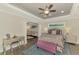 Elegant main bedroom with a seating area, tray ceiling, and a luxurious bed with designer bedding at 6444 Alhambra Ave, North Port, FL 34291