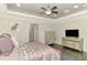 Comfortable main bedroom featuring a tray ceiling, elegant decor, and plenty of natural light at 6444 Alhambra Ave, North Port, FL 34291