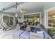 Relaxing covered patio featuring comfortable seating, ceiling fan, and access to the pool area at 6444 Alhambra Ave, North Port, FL 34291