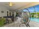 Covered patio with comfortable seating, a hanging chair, a ceiling fan, and a view of the pool at 6444 Alhambra Ave, North Port, FL 34291