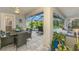 Inviting screened-in pool area with a dining table, seating, and lush landscaping at 6444 Alhambra Ave, North Port, FL 34291