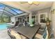 An ample outdoor dining set offers plenty of room to enjoy meals near the pool at 6444 Alhambra Ave, North Port, FL 34291