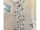 Close-up of a stand-up shower with modern tile and built-in shelving for a spa-like experience at 6444 Alhambra Ave, North Port, FL 34291