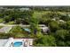 An aerial view shows a backyard with above ground pool and tropical greenery surrounding the property at 1027 Coral Ridge Dr, Punta Gorda, FL 33950