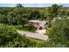 Aerial view showcasing the property's layout, landscaping, and surrounding greenery at 1027 Coral Ridge Dr, Punta Gorda, FL 33950