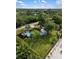 Aerial view of a backyard with an above ground pool and a small shed in a lush, tropical landscaped yard at 1027 Coral Ridge Dr, Punta Gorda, FL 33950