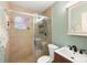 Bathroom with updated sink, shower with glass door, decorative window, and neutral wall tones at 1027 Coral Ridge Dr, Punta Gorda, FL 33950