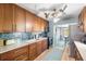 Kitchen with wooden cabinets, stainless steel appliances, blue backsplash, and a breakfast nook at 1027 Coral Ridge Dr, Punta Gorda, FL 33950