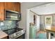 Kitchen featuring stainless steel appliances, wooden cabinets, and breakfast nook at 1027 Coral Ridge Dr, Punta Gorda, FL 33950