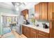 Bright kitchen with wooden cabinets, stone countertops, stainless steel appliances and a breakfast nook at 1027 Coral Ridge Dr, Punta Gorda, FL 33950