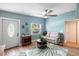 Cozy living room with a front door, shoe rack, ceiling fan and a leaf-patterned rug at 1027 Coral Ridge Dr, Punta Gorda, FL 33950