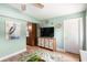 Living room with a TV, cabinet, painting, ceiling fan and a leaf-patterned rug at 1027 Coral Ridge Dr, Punta Gorda, FL 33950