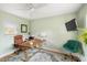 Office with a green accent chair, ceiling fan, wood flooring, a desk and a monitor at 1027 Coral Ridge Dr, Punta Gorda, FL 33950