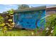 Unique outdoor mural with ocean theme, adding charm and artistic flair to the property at 1027 Coral Ridge Dr, Punta Gorda, FL 33950
