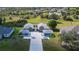Aerial view showcasing the home's unique layout with a central courtyard, expansive driveway, and lush landscaping at 1115 San Cristobal Ave, Punta Gorda, FL 33983