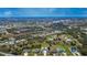 Scenic aerial view of a residential area with well-maintained homes, interspersed with green spaces, and a nearby lake at 1115 San Cristobal Ave, Punta Gorda, FL 33983