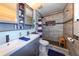 Updated bathroom with dual sinks, a tiled walk-in shower, and contemporary fixtures and decor at 1115 San Cristobal Ave, Punta Gorda, FL 33983