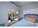 Cozy bedroom featuring a sliding door to a screened porch, wood flooring, and a relaxed atmosphere at 1115 San Cristobal Ave, Punta Gorda, FL 33983