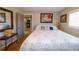 Comfortable bedroom featuring wood floors, a neutral color scheme, and a view of the kitchen area at 1115 San Cristobal Ave, Punta Gorda, FL 33983
