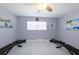 Home exercise room with weight training equipment, neutral walls, and beach-themed wall art at 1115 San Cristobal Ave, Punta Gorda, FL 33983