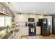 Well-appointed kitchen featuring stainless steel appliances, granite countertops, and ample natural light at 1115 San Cristobal Ave, Punta Gorda, FL 33983